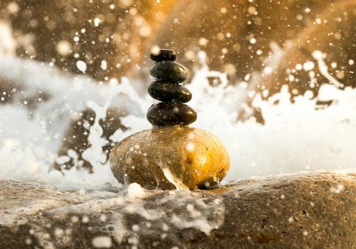Zen stones in water illustrating tranquility and mental focus